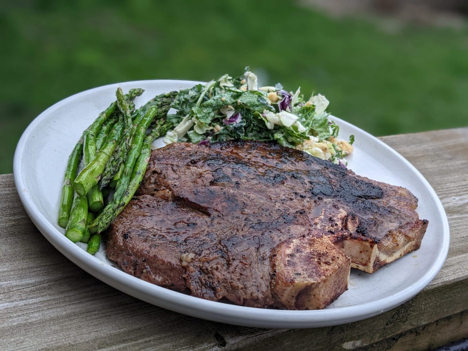 Classic-T-Bone-Steak-with-Grilled-Asparagus-and-Creamy-Kale-Caesar-Salad-Nutrafarms-Grass-Fed-Steak-Image-3 Classic-T-Bone-Steak-with-Grilled-Asparagus-and-Creamy-Kale-Caesar-Salad-Nutrafarms-Grass-Fed-Steak-Image-3